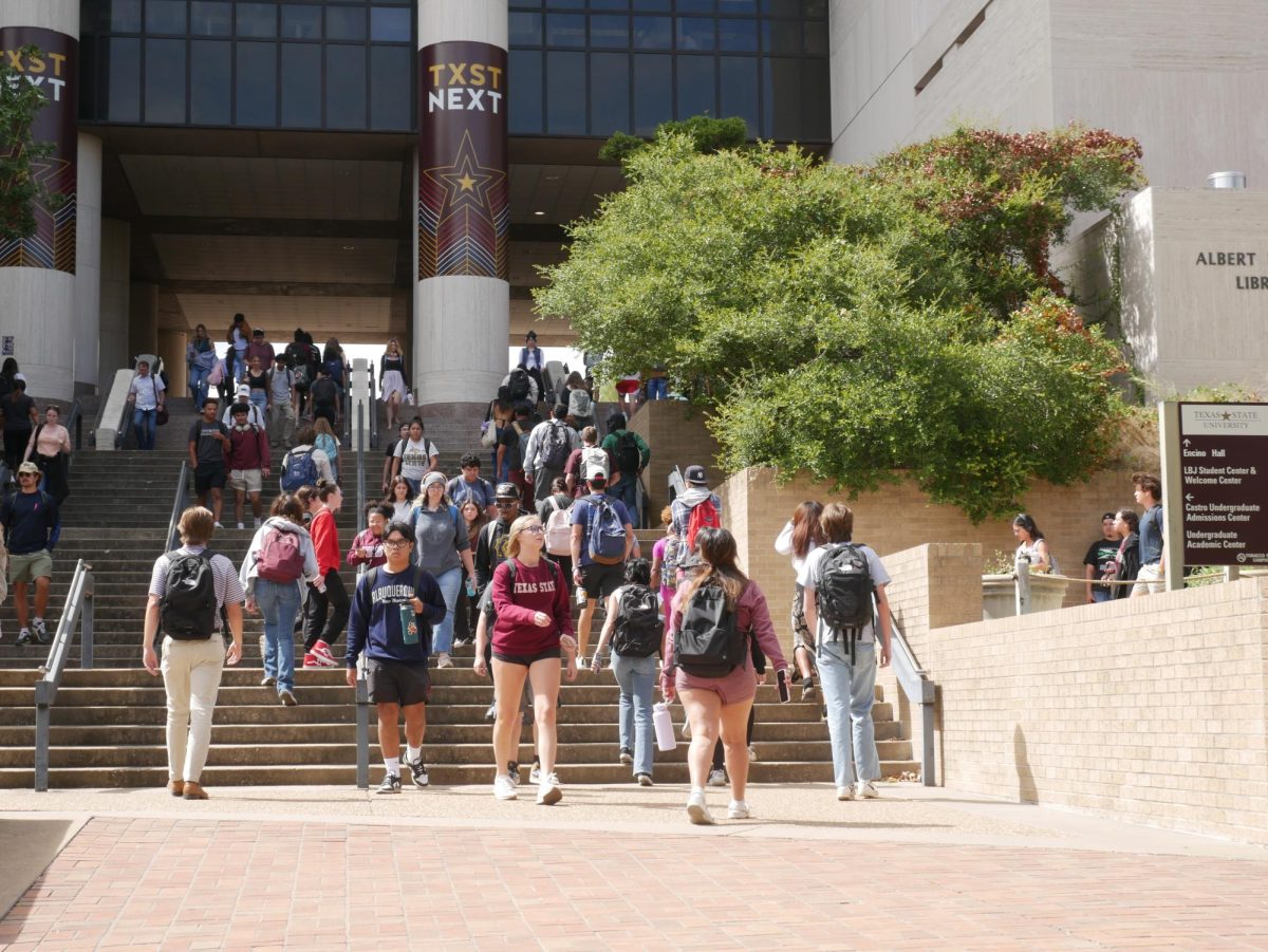 Texas State students walk between classes, Monday, Oct. 9, 2023 at Alkek Library.
