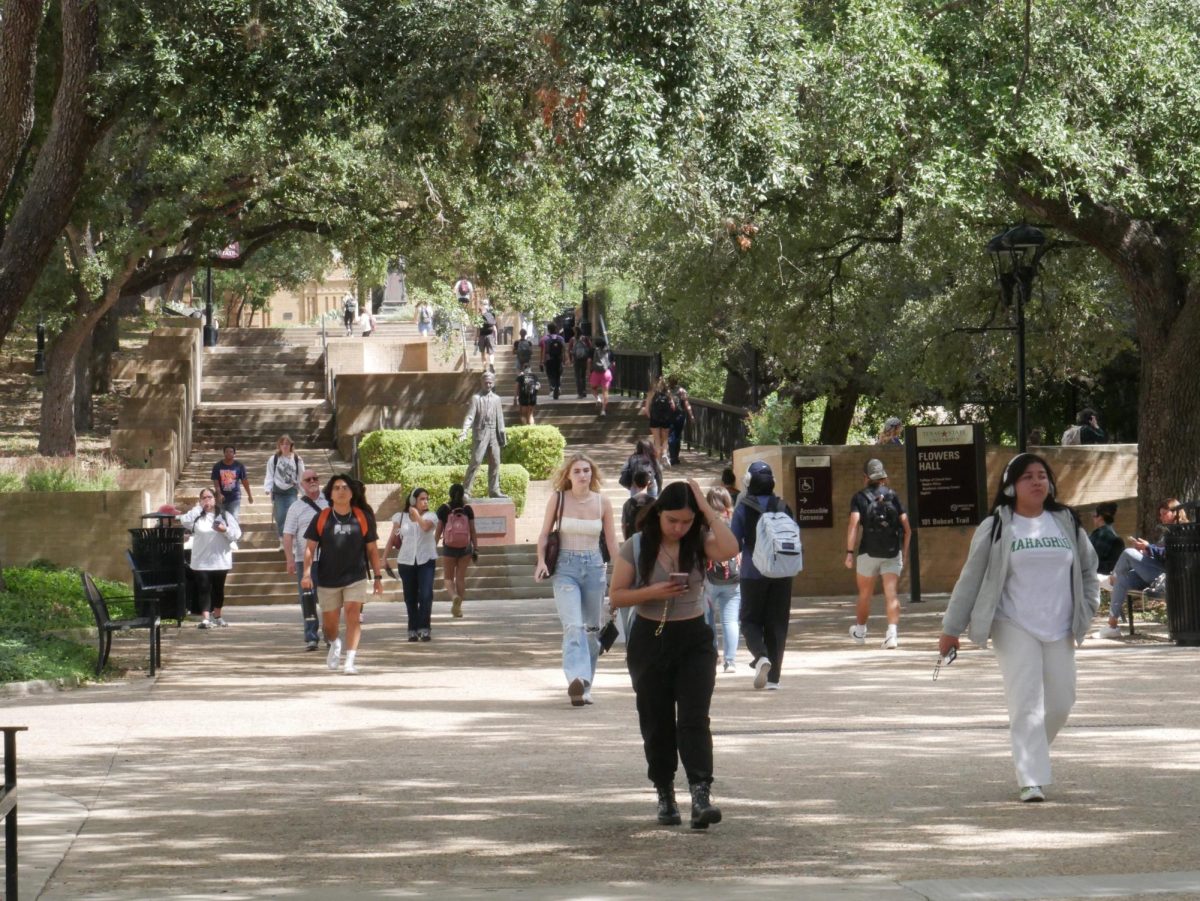 Texas State students walk between classes, Monday, Oct. 9, 2023 at The Quad. 
