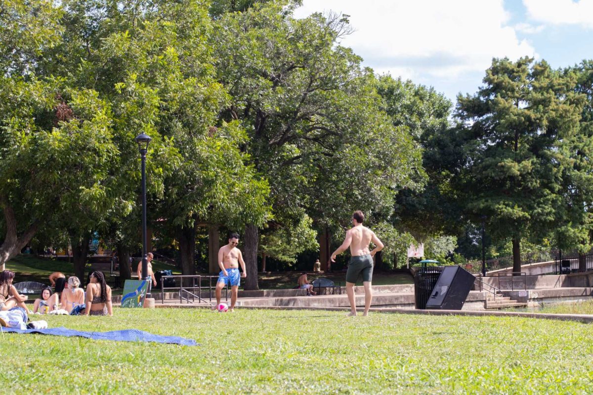 Two friends kick a ball around, Monday, Aug. 8, 2021 at Sewell Park in San Marcos.