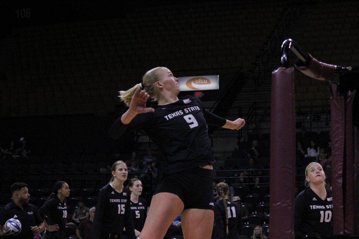 Texas State junior outside hitter Sophie Childs (9) practices her spikes pre-game, Sept. 21, 2023, at Strahan Arena.