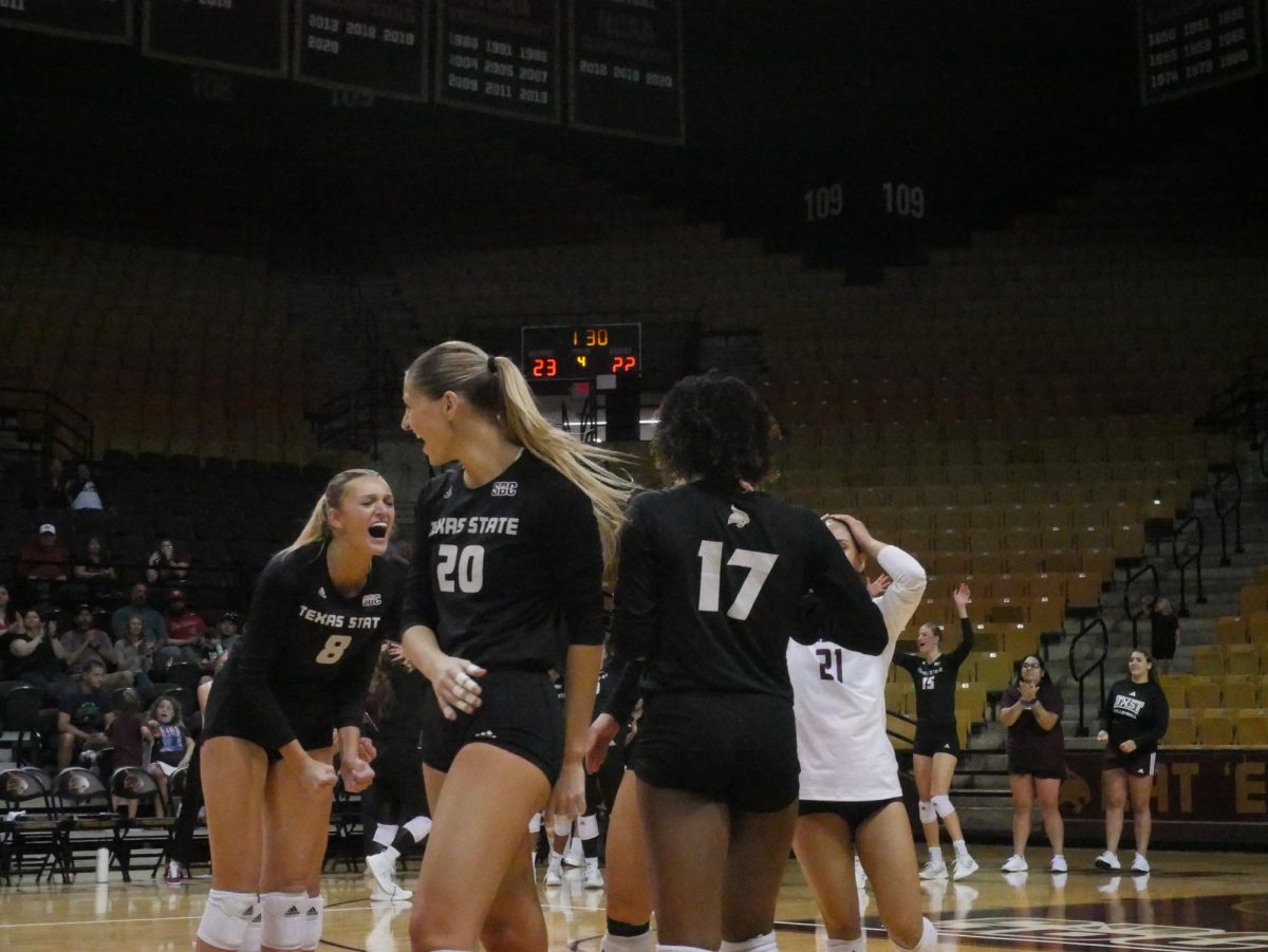 The Texas State volleyball team celebrates a point during the match against Louisiana-Lafayette, Friday, Oct. 8, 2023, at Strahan Arena. 
