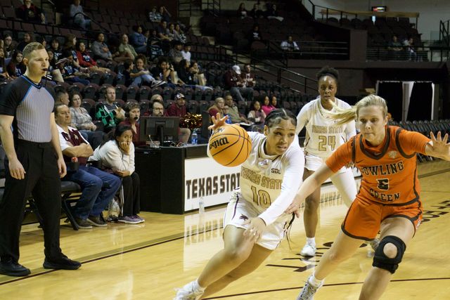 Texas State sophomore point guard Kenndey Claybrooks (10), dribbles past a defender, Saturday, Nov. 11, 2023, at Strahan Arena. 