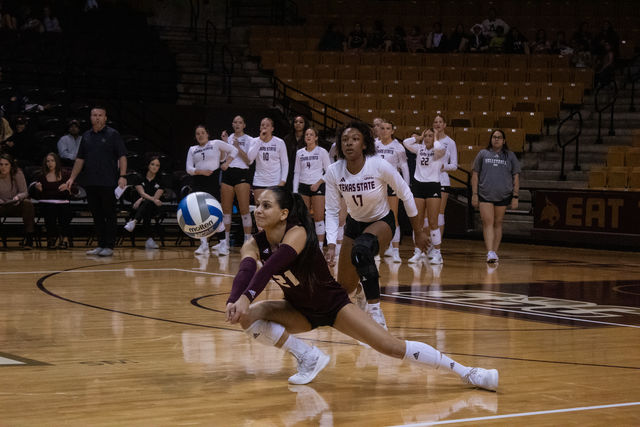 Texas State junior libero Alyssa Ortega (21) dives to hit the ball to a teammate during the game against Coastal Carolina, Friday, Nov. 10, 2023 at Strahan Arena.