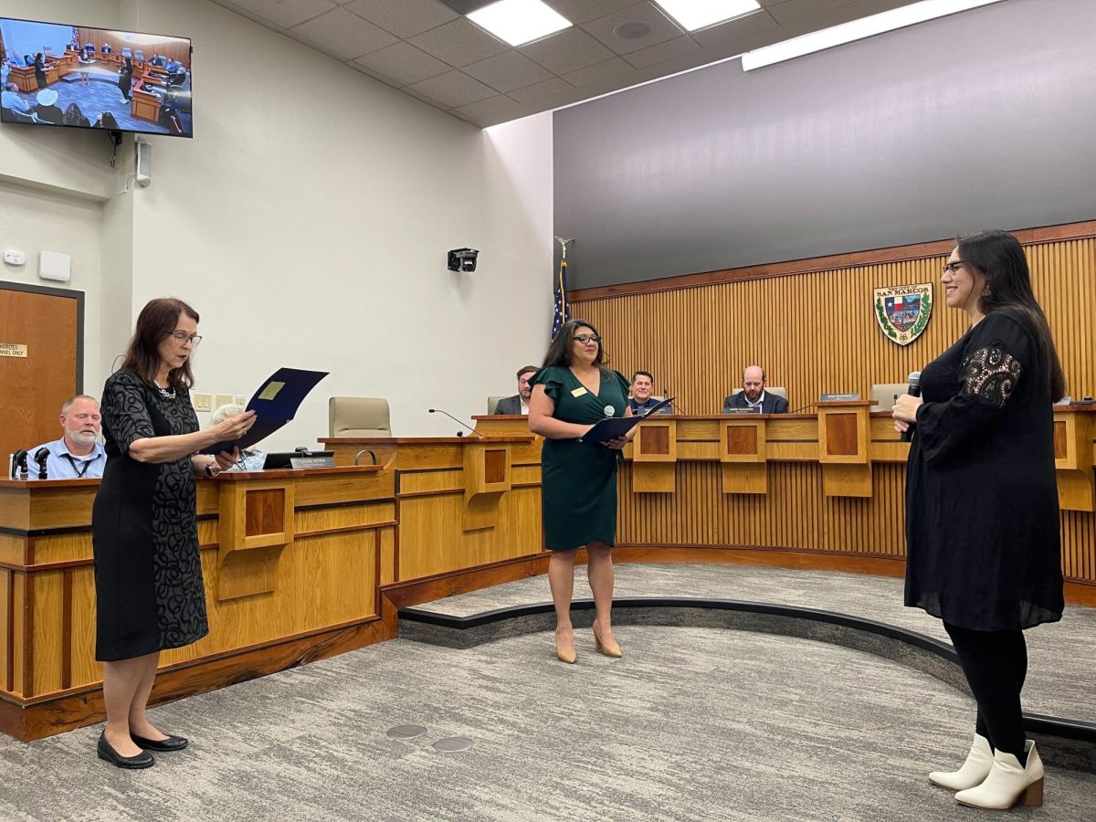 City Council Place 3 elect Alyssa Garza (rights) is sworn in by San Marcos Mayor Jane Hughson (left).