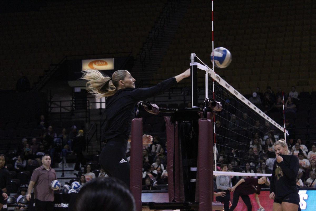 Texas State sophomore middle blocker Bailey Hanner (20) spikes the ball over the net during warm-ups at the game against Coastal Carolina, Thursday, Nov. 9, 2023 at Strahan Arena.