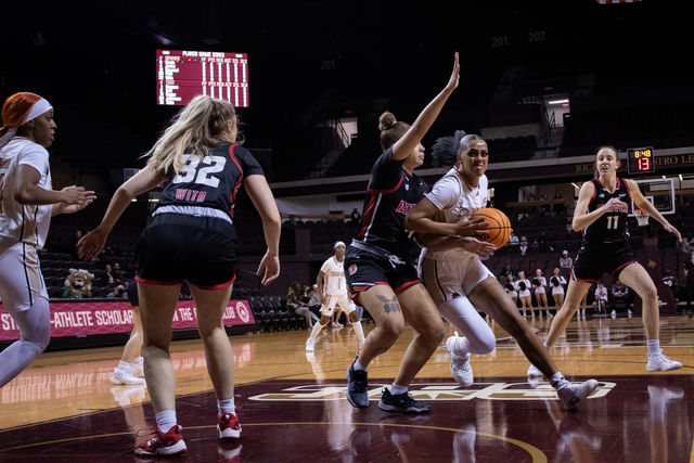 Texas State junior forward Jaylin Foster (11) pushes past a defender during the game against Denver, Thursday, Dec. 14, 2023, at Strahan Arena.