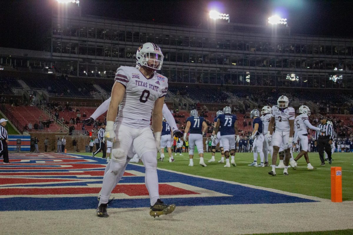 Texas State redshirt senior linebacker Brian Holloway (0) hypes the crowd after a defensive stop versus Rice during the SERVPRO First Responder Bowl game, Tuesday, Dec. 26, 2023, at Gerald J. Ford Stadium.