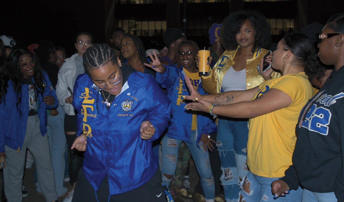 Texas State theater senior Krystal Bennett dances during Hump Day surrounded by Sigma Gamma Rho Inc., Wednesday, Nov. 29, 2023, at the LBJ Mall.