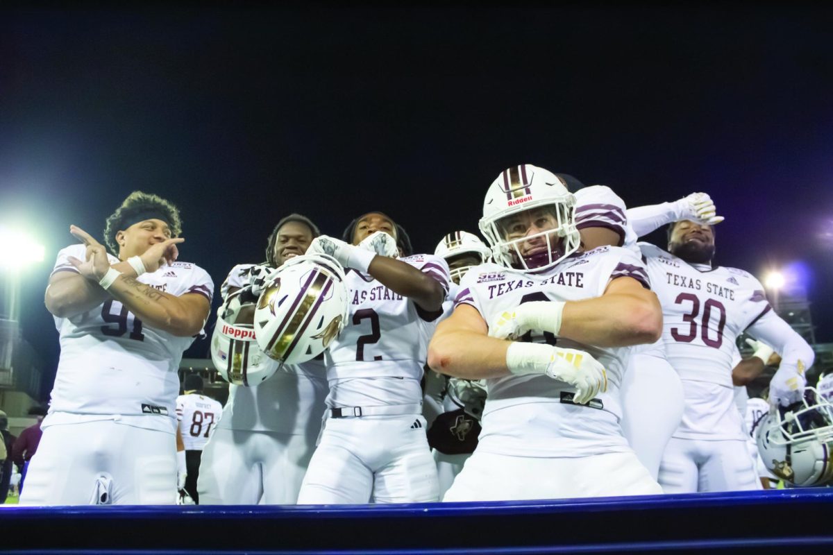 Texas State redshirt senior linebacker Brian Holloway (0) celebrates a defensive touchdown with his teammates, Tuesday, Dec. 26, 2023, at Gerald J. Ford Stadium in Dallas. 