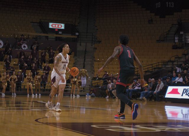 Texas State freshman guard Kaden Gumbs (11) faces off against a player from Ball State on the court, Saturday, Feb. 10, 2024, at Strahan Arena.
