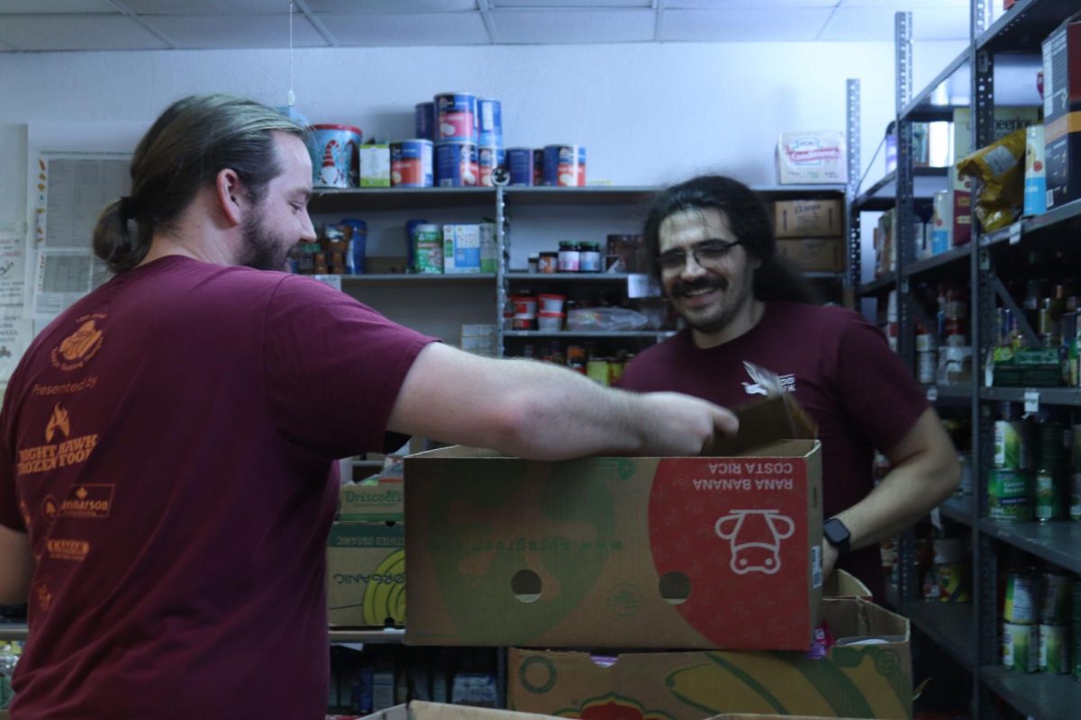 story Capes (left) organizes food alongside his coworker Francisco Chico Macedo (right), Monday, Feb. 26, 2024 inside Hays County Food Bank.