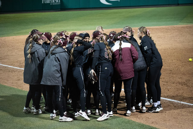 The Texas State softball team huddles up before batting during the game against Texas, Wednesday, Feb. 28, 2024, at Bobcat Softball Stadium.