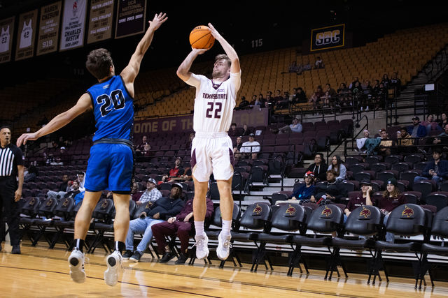 Texas State guard sophomore Coleton Benson (22) shoots from the three point line during the game against LeTourneau, Monday, Dec. 18, 2023, at Strahan Arena.
