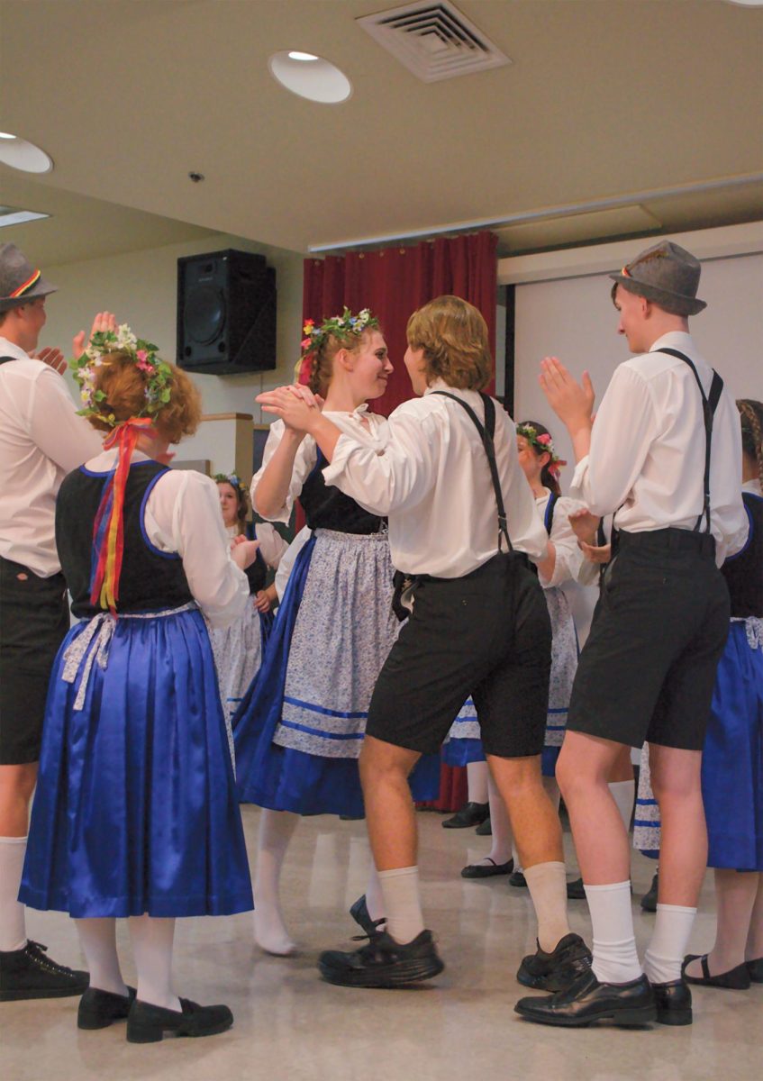 Two students from La Grange High School join in a partner dance during their German folk piece, Saturday, Feb. 24, 2024, at Centennial Hall.