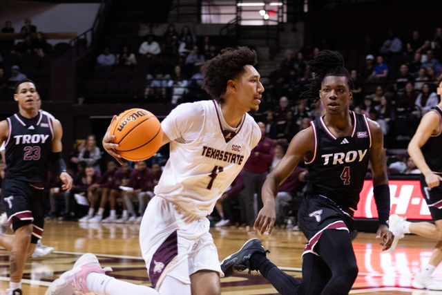 Texas State sophomore forward Davion Sykes (4) runs the ball down the court during the game against Troy, Friday, March, 1, 2024, at Strahan Arena.