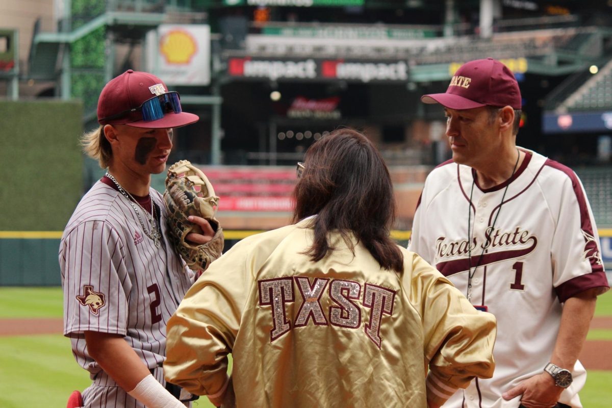 Texas State President, Kelly Damphousse, and his wife, Beth Damphousse, talk to Chase Mora (2) prior to the game,  March 2, 2024, Minute Maid Park.