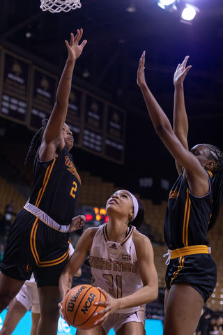 Texas State junior forward Tiffany Tullis (31) attempts a shot against two ULM defenders, Friday, Mar. 1, 2024, at Strahan Arena. 