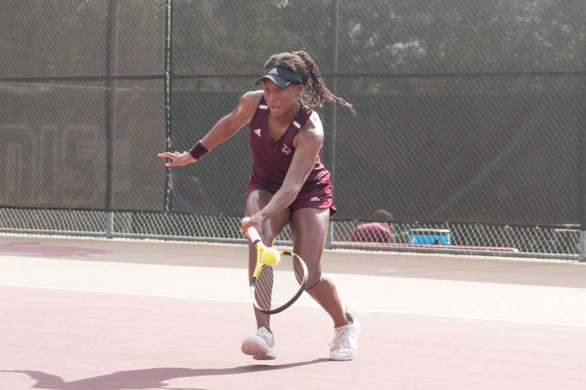 Texas State senior Mae McCutcheon forehands the ball during her match at the TXST Fall Invite, Sept. 30, 2023, at Bobcat Tennis Complex.