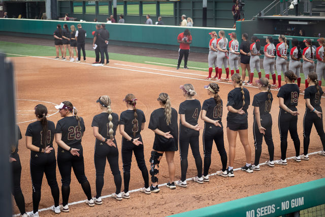 The Texas State softball team stand for the National Anthem before the game against  Louisiana-Lafayette, Saturday, April 13, 2024, at Texas State Softball Complex.