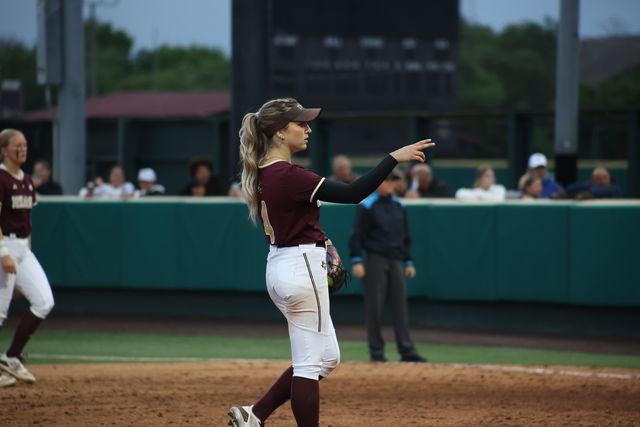 Texas State senior pitcher Jessica Mullins (4) communicates the number of outs to her team during the game against Texas A&M, Wednesday, March 20, 2024, at Bobcat Softball Stadium.