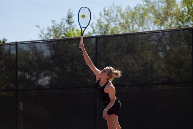 Texas State senior Mae McCutcheon goes to serve the ball during the doubles match against Troy, Friday, April 5, 2024, at Bobcat Tennis Complex.