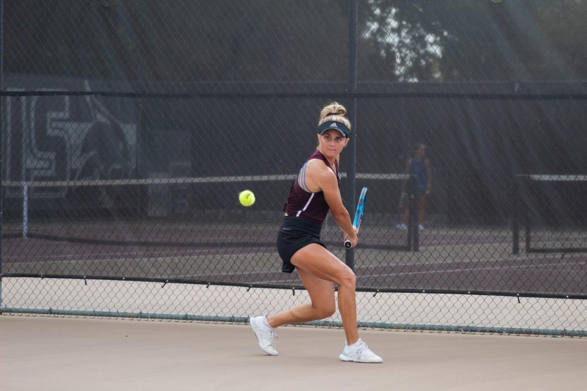 Texas State graduate student tennis player Callie Creath rushes to hit the ball during her singles match, September 30, 2023, at Bobcat Tennis Complex.