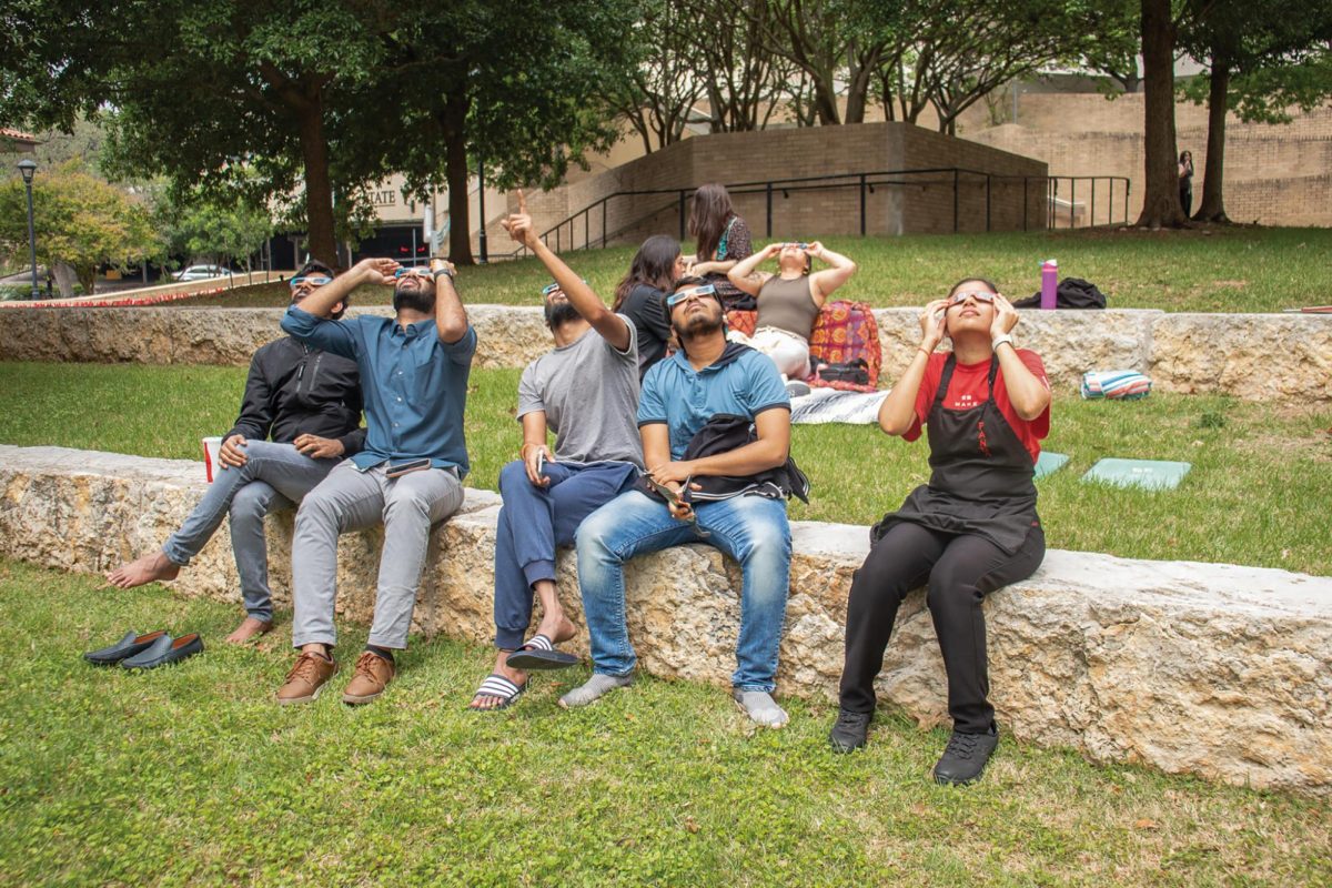 Members of the community gather to observe the solar eclipse, Monday, April 8, 2024, at Texas State.
