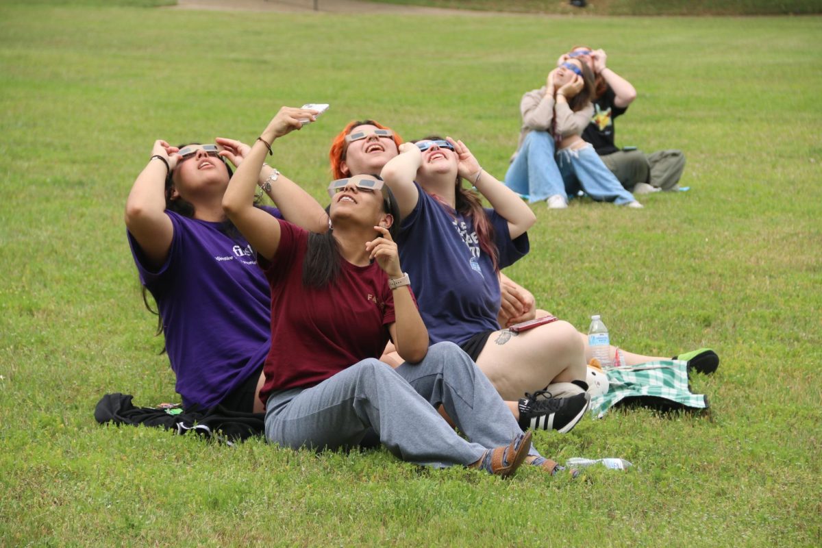 Students gather outside of Blanco Hall to experience the eclipse as it unfolds, Monday, April 8, 2024, at Texas State.