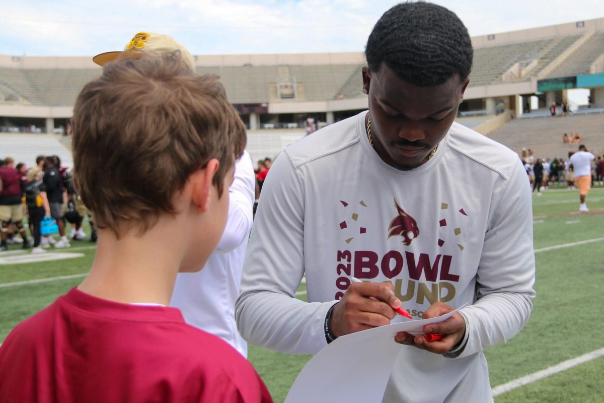 Texas State graduate student quarterback Jordan McCloud signs autographs for fans after the maroon and gold spring game, Saturday, April 13, 2024, at Bobcat Stadium. 