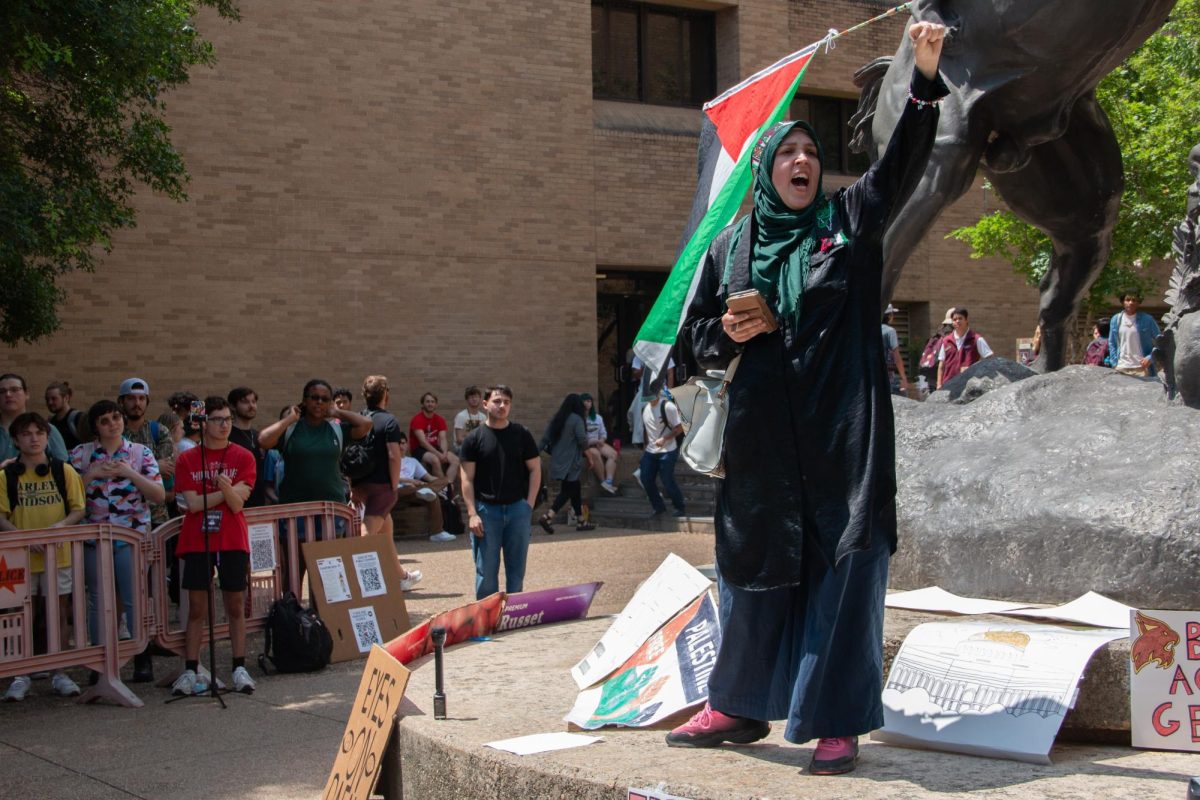 Amanda Smith raises her fist while leading a chant at the sit-in for Palestine on The Quad on Monday, April 29, 2024. 