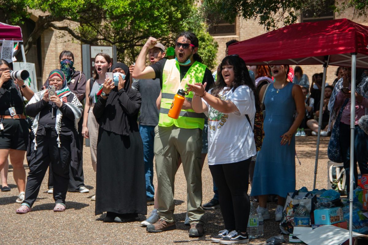 A group of volunteers and supporters of the sit-in for Palestine cheer on at The Quad on Monday, April 29, 2024. 