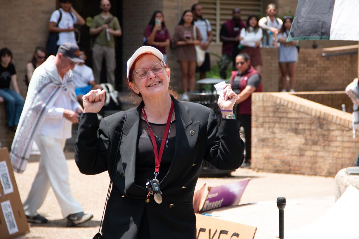 Texas State University History Professor Elizabeth Bishop dances for a crowd of supporters at the sit-in for Palestine on The Quad on Monday, April 29, 2024. 