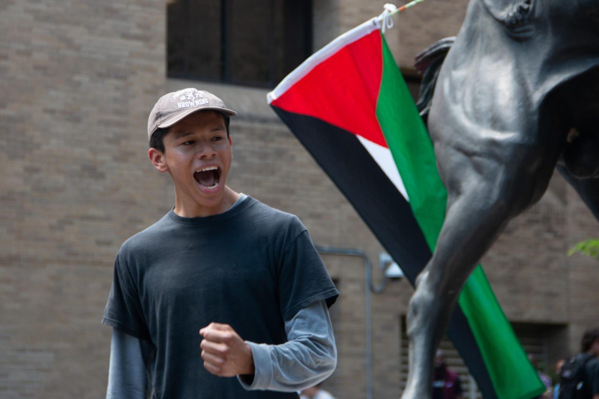 Allen Dominguez, co-chair of the Young Democratic Socialists of America at Texas State, rallies the crowd with a chant at the sit-in for Palestine on the stallions statue on The Quad on Monday, April 29, 2024. 