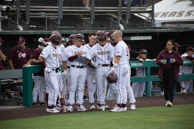 The Texas State baseball team gathers around Head Coach Steven Trout to discuss the next inning during the game against South Alabama, Friday, April 19, 2024, at Bobcat Ballpark.