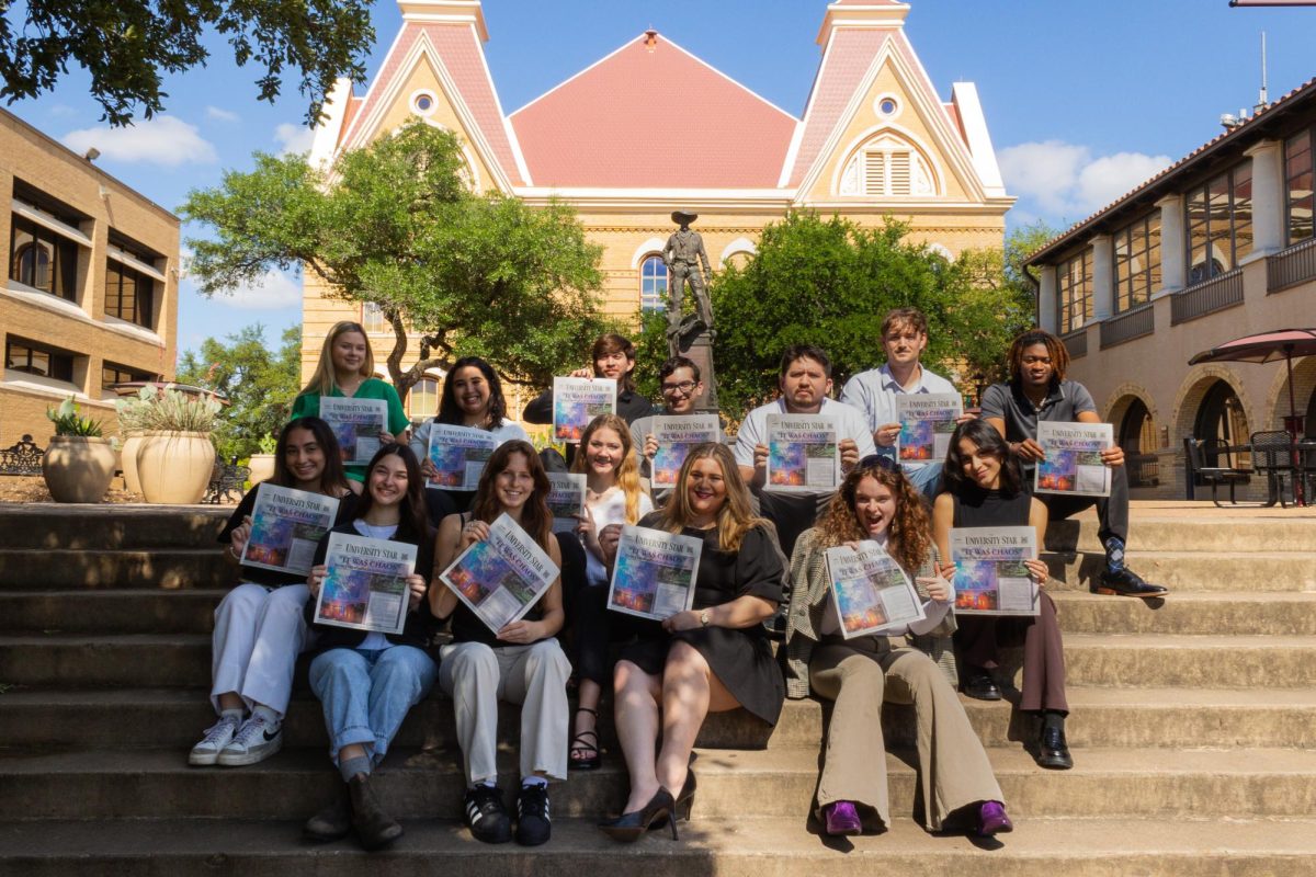 The University Star editorial board poses with a recent issue on the Old Main stairs, Sunday, April 21, 2024.