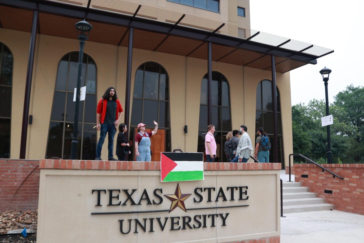 Texas State students gather outside J.C. Kellam Administration Building to deliver a letter to President Kelly Damphousse against Executive Order 44 on Wednesday, May 8, 2024.