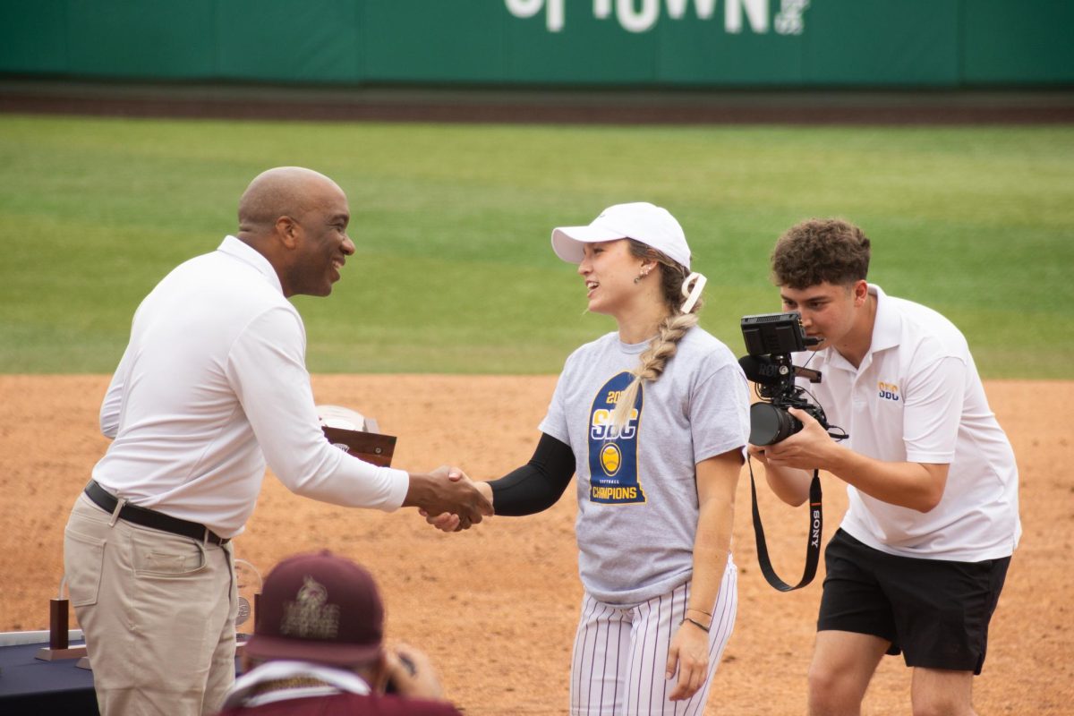 Texas State senior pitcher Jessica Mullins (4) receives her trophy following the Sun Belt Conference Championship victory over the University of Louisiana-Lafayette, Saturday, May 11, 2024, at Bobcat Softball Stadium.