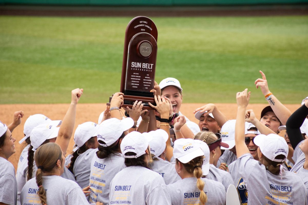 The Texas State softball team celebrate with the Sun Belt Conference tournament championship trophy following the victory over Louisiana-Lafayette, Saturday, May 11, 2024, at Bobcat Softball Stadium.