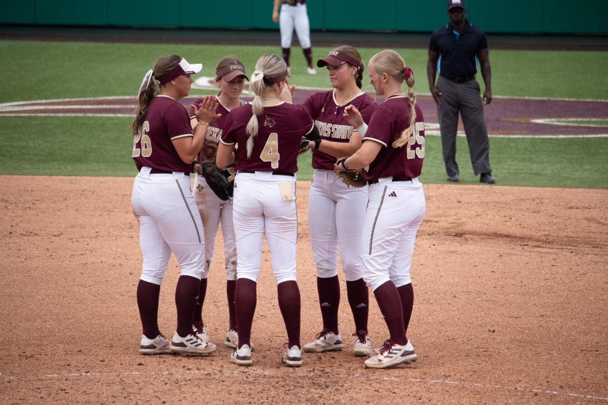Texas States softball team huddles before an inning starts during the Sun Belt Conference semifinals against Marshall, Friday, May 10, 2024, at Bobcat Softball Stadium.