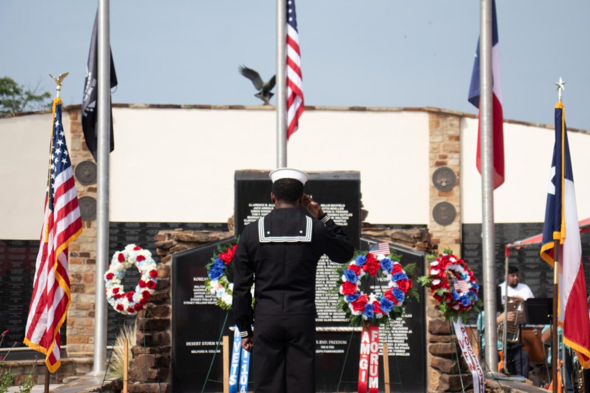 U.S. Navy member David Franklin salutes the wreaths placed to honor service members who were killed in action, Monday, May 27, 2024, at the Hays County Veterans Memorial  during the 2024 Memorial Day ceremony.