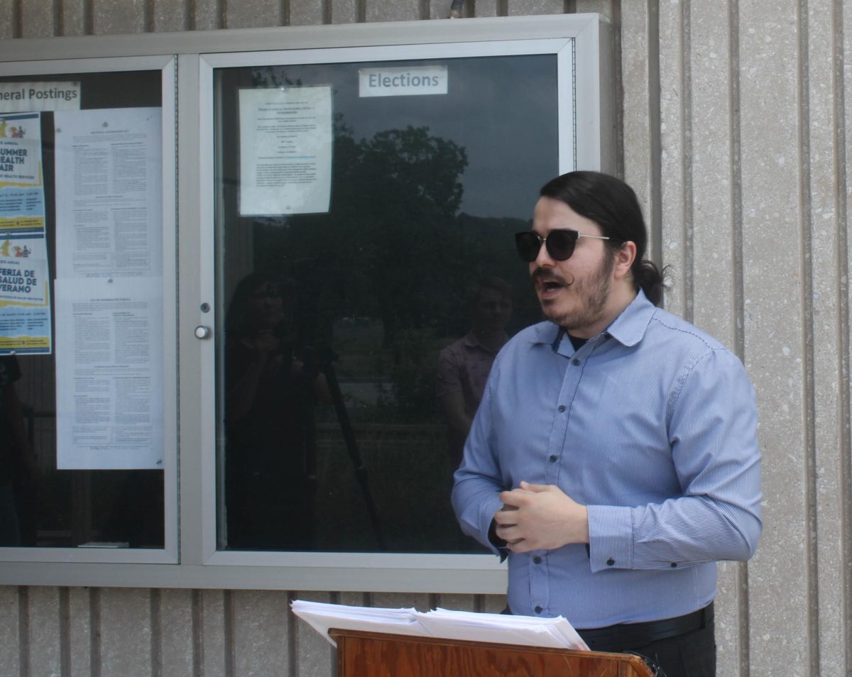 Eric Martinez, executive director of Mano Amiga Safe Communities, speaks outside San Marcos City Hall before submitting signatures to repeal the San Marcos Police Departments civil service protections on April 30, 2024.
