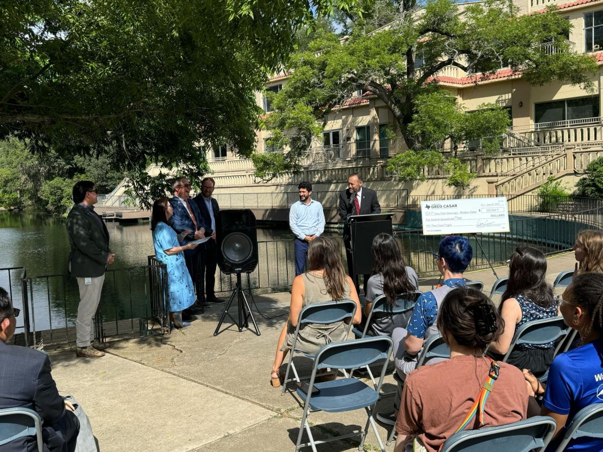 San Marcos Mayor Jane Hughson, Representative Greg Casar and Texas State President Kelly Damphousse speak in front of a crowd Tuesday, June 18 at Spring Lake.