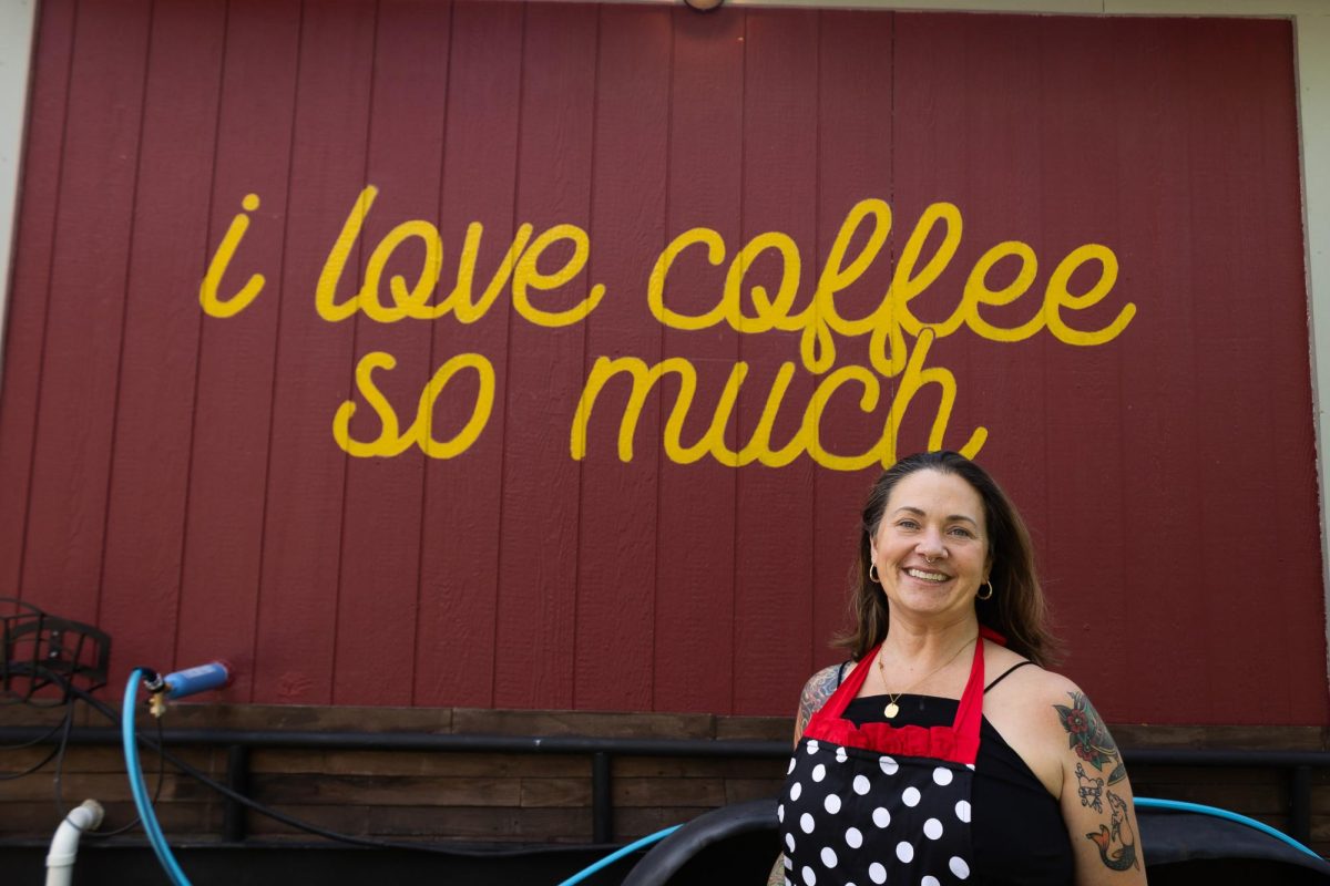 Cafe owner Krendi Harmon stands in front of new sign at Cafe Cortado Friday, June 28, 2024, at 221 North Street.