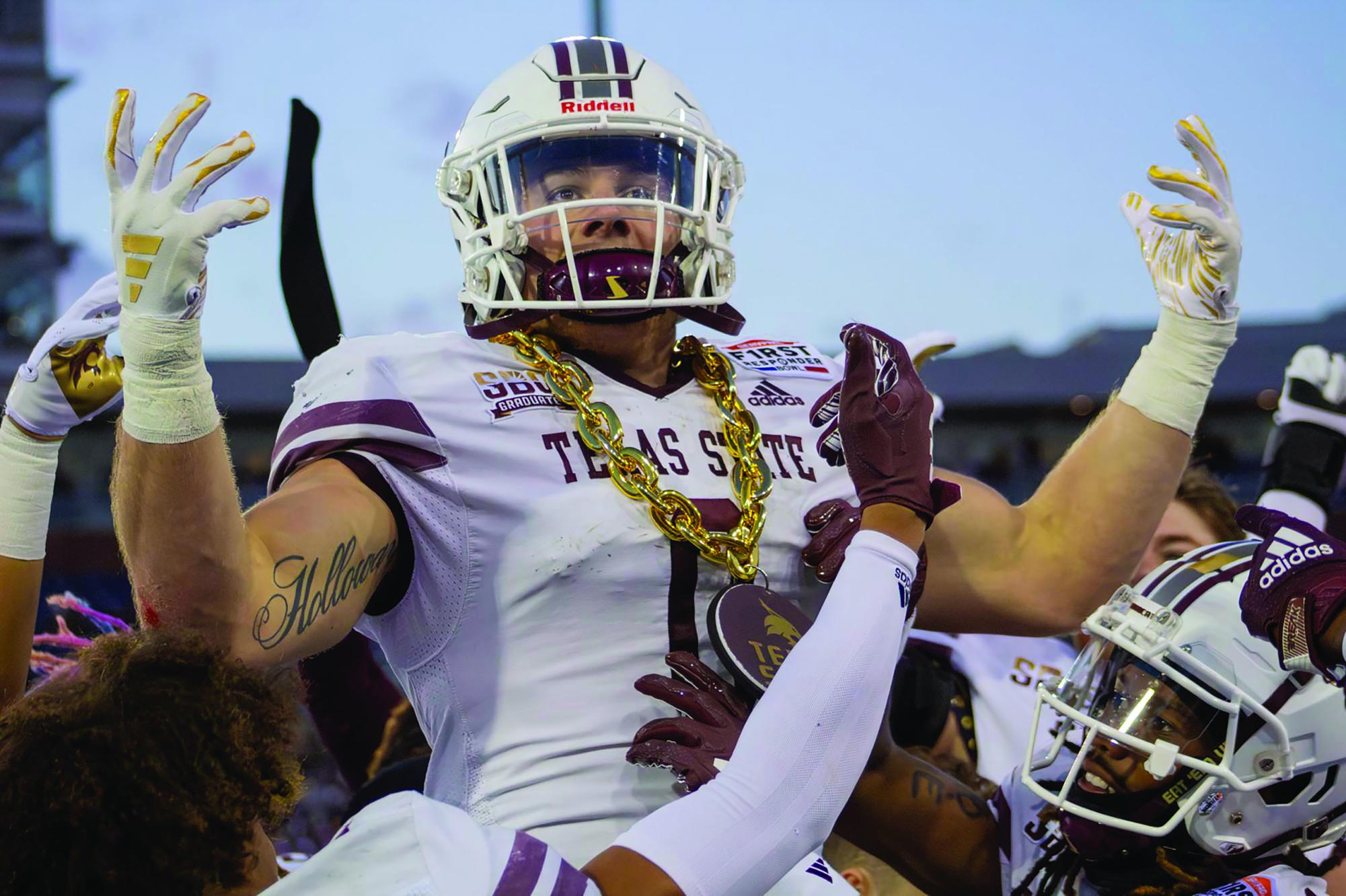 Senior linebacker Brian Holloway celebrates with the turnover chain after a pick-six in his final game versus Rice during the SERVPRO First Responder Bowl game, Tuesday, Dec. 26, 2023, in Gerald J. Ford Stadium in Dallas.