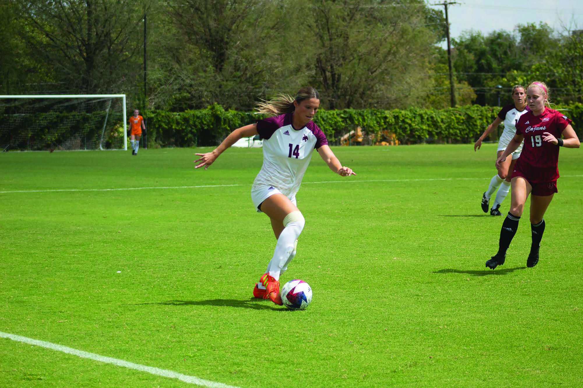 Texas State junior defender Anna Dunch (14) dribbles the ball down the sideline during the game against Louisiana-Lafayette, Sunday, Sept. 17, 2023, at Bobcat Soccer Complex.