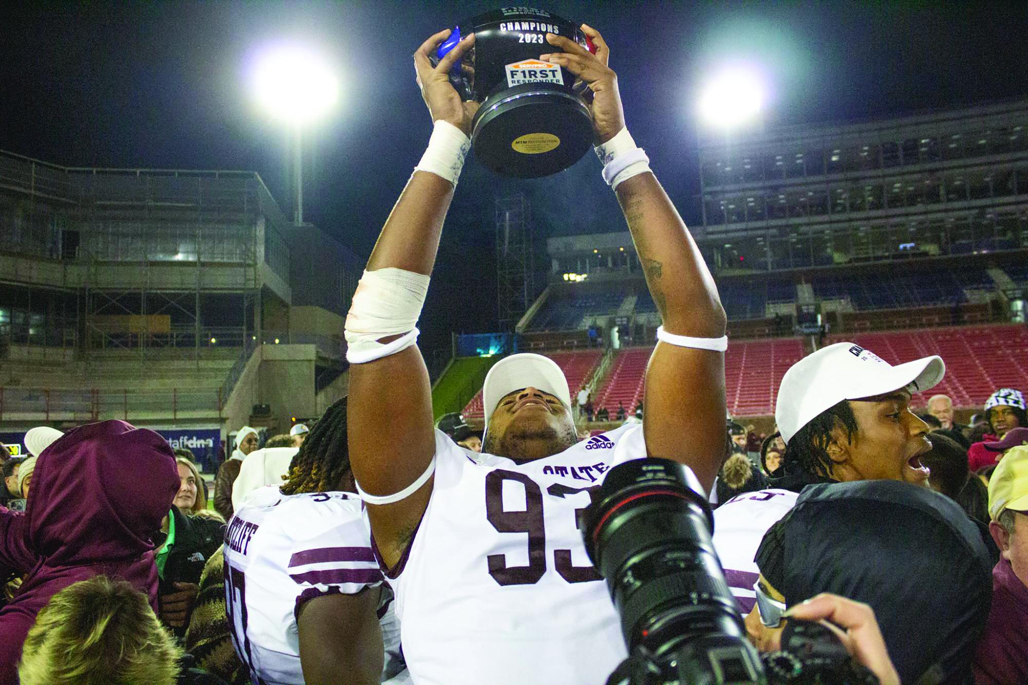 Junior defensive tackle Christian Rorie lifts the 2023 SERVPRO First Responder Bowl Trophy after the victory over Rice University, Tuesday, Dec. 26, 2023, in Gerald J. Ford Stadium.