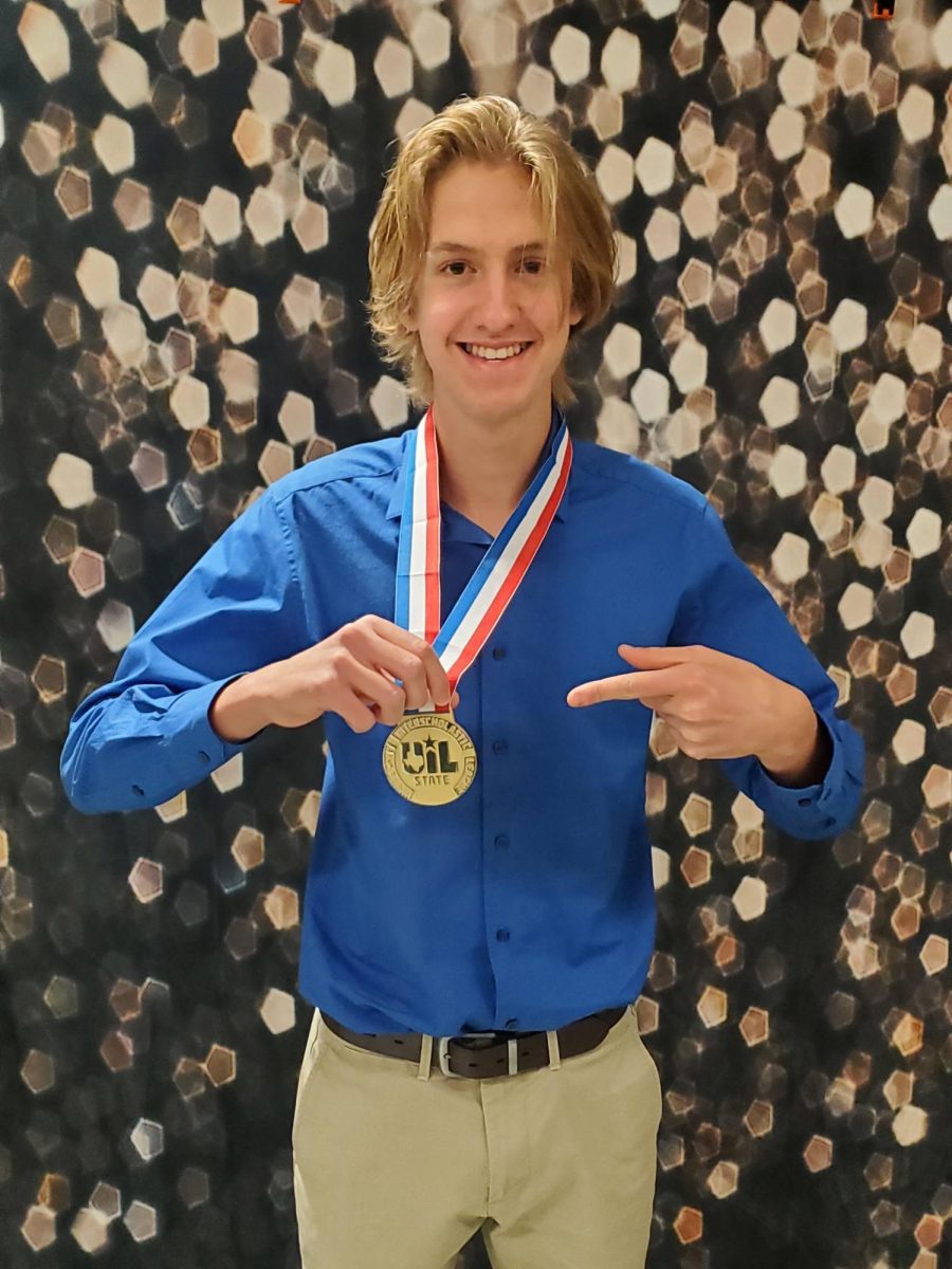 Matthew Wright poses with University Interscholastic League medal after his win with the Cedar Park High School Band in November 2021.