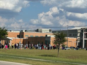 People waiting amidst a lockdown, Tuesday, Sept. 24, 2024  outside San Marcos High School.