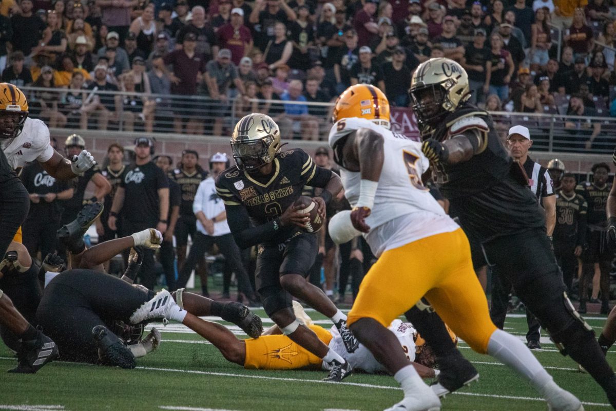 Texas State redshirt senior quarterback Jordan McCloud (3) pushes through the Arizona State defense,Thursday, Sept. 12, 2024, at UFCU Stadium.