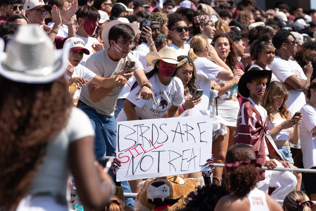 Texas State's mascot Boko holds up sign "Birds are still not real" in front of the student section amping up the crowd during the I-35 Showdown. Saturday, Sept. 7, 2024, at Jim Wacker Field at UFCU Stadium.